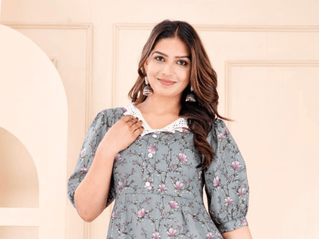 Person wearing a floral dress with puff sleeves, standing against a neutral background.